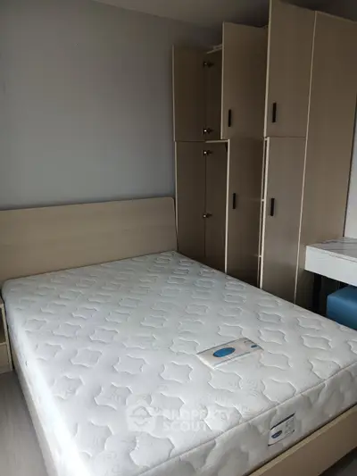 Modern bedroom with sleek wooden furniture and comfortable mattress, perfect for restful nights.