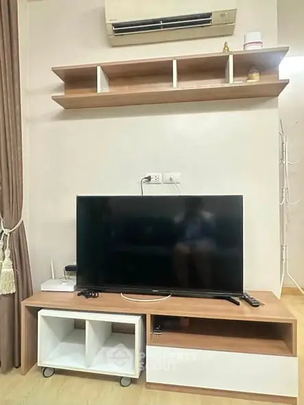Modern living room with sleek TV setup and stylish shelving, perfect for contemporary urban living.