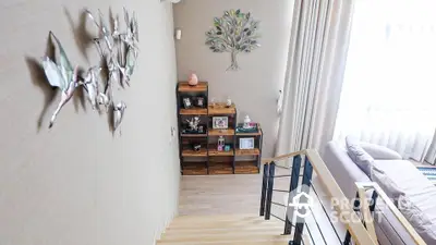 Cozy and inviting living space with natural light, tasteful wall art, and warm wooden flooring, perfect for modern living.