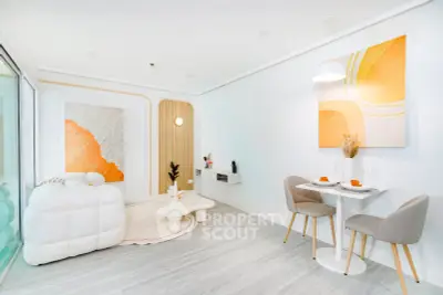 Modern living room with stylish decor and dining area, featuring contemporary art and cozy seating.