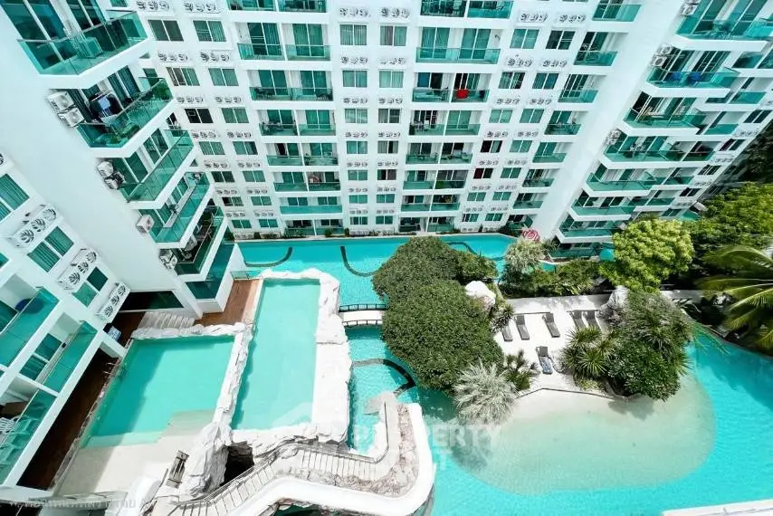 Luxurious condominium with stunning pool and lush greenery, perfect for resort-style living.