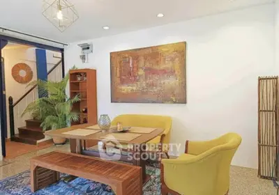 Charming living room with modern decor and vibrant yellow chairs