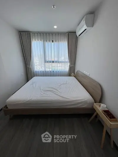 Modern bedroom with large window and air conditioning unit