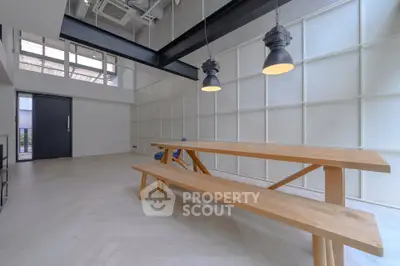 Spacious modern interior with high ceilings and stylish lighting, perfect for contemporary living.