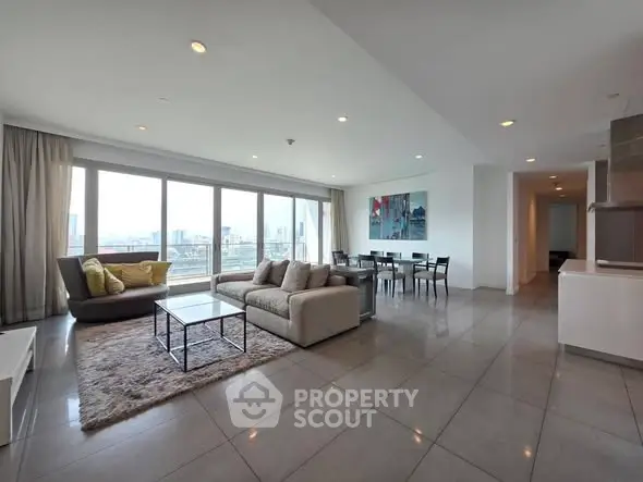 Spacious modern living room with panoramic city views and elegant furnishings.