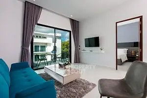 Modern living room with blue sofa and balcony view