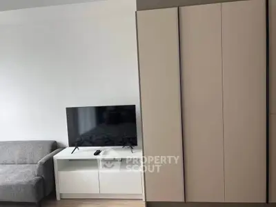 Modern living room with sleek TV stand and cozy gray sofa