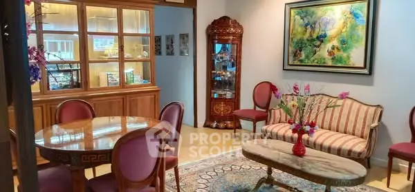 Elegant living room with classic furniture and vibrant artwork, perfect for sophisticated gatherings.