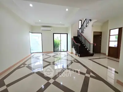 Spacious modern living room with elegant tile flooring and staircase