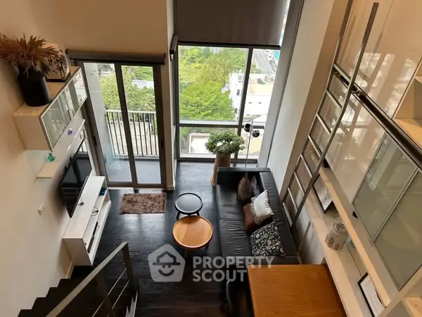 Modern loft apartment with high ceilings and balcony view