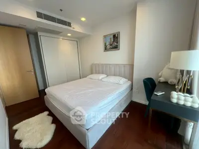 Modern bedroom with cozy bed, elegant decor, and stylish desk in a chic apartment.