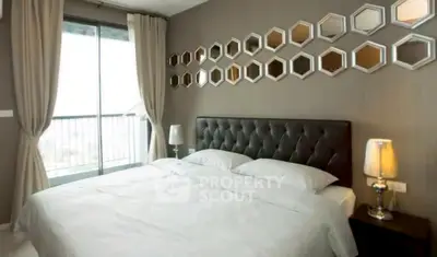 Elegant bedroom with modern decor and large window for natural light