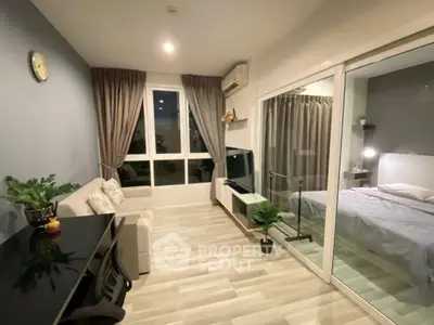 Modern living room with stylish decor and adjacent bedroom in a cozy apartment.