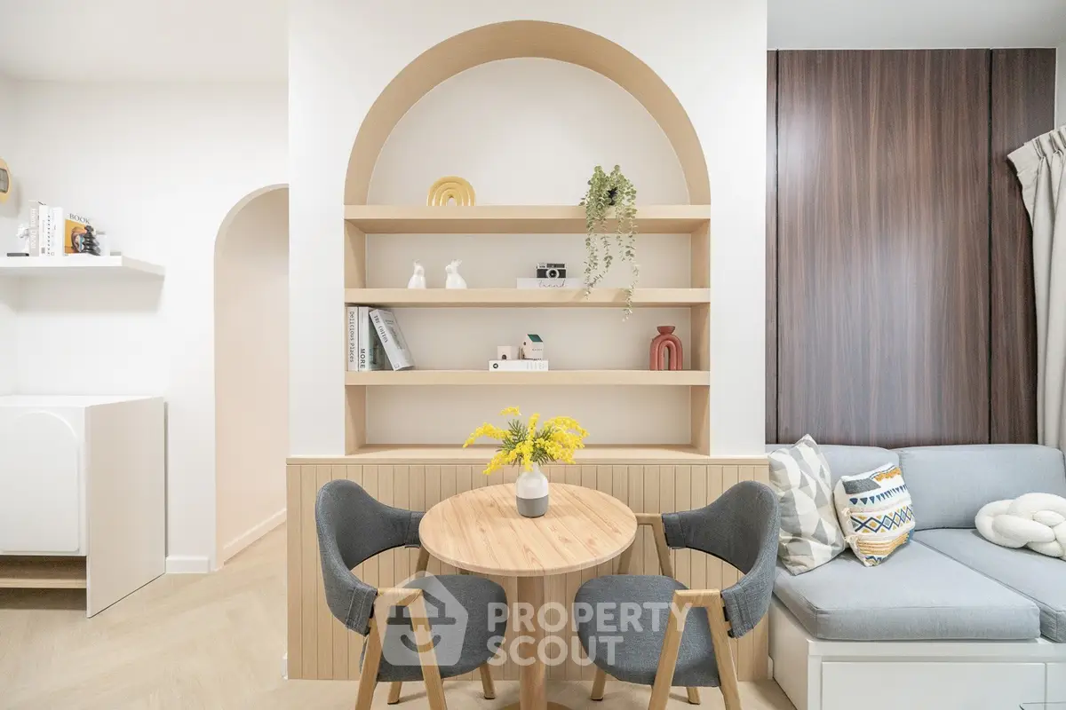 Chic modern living room with cozy seating and stylish shelving, perfect for urban living.