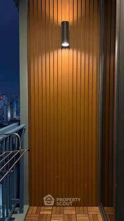 Stylish balcony with modern lighting and city view, perfect for urban living.