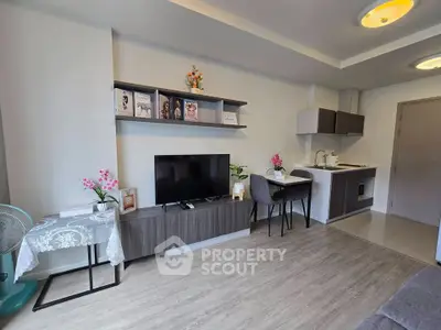 Modern living room with open kitchen and stylish decor in a cozy apartment.