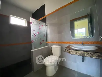 Modern bathroom with floral glass partition and sleek fixtures