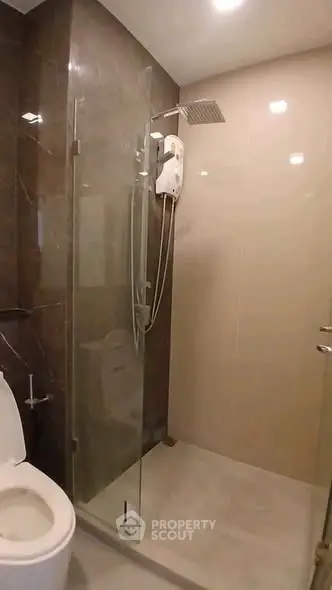 Modern bathroom with glass shower enclosure and sleek fixtures