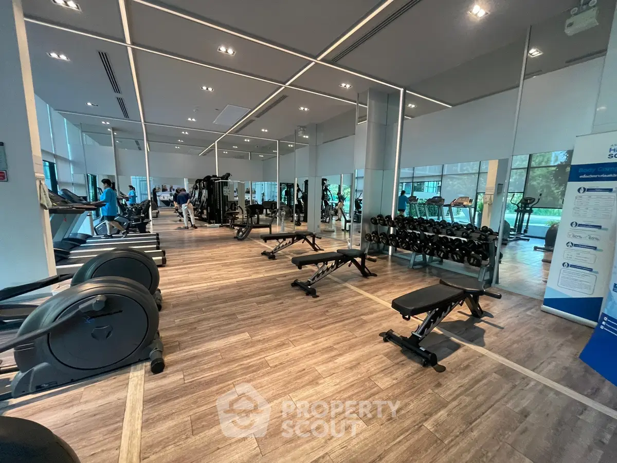 Spacious modern gym with state-of-the-art equipment and large mirrors, perfect for fitness enthusiasts.