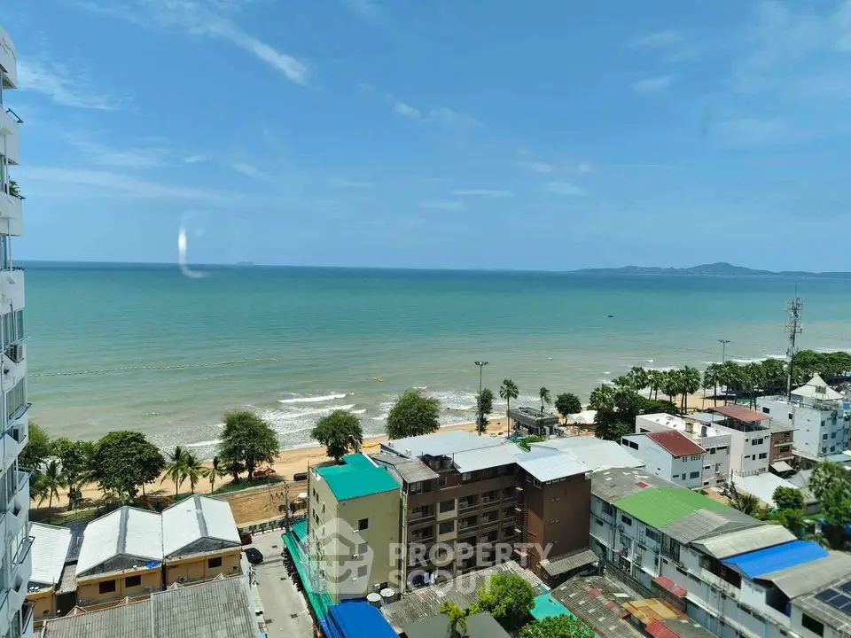 Stunning ocean view from high-rise building overlooking beach and cityscape.
