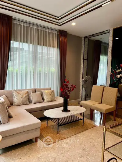 Elegant living room with modern decor and large windows