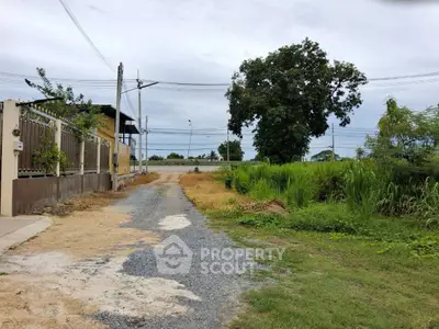 Spacious land plot with potential for development, featuring lush greenery and easy road access.