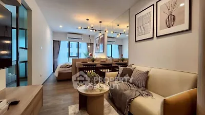 Modern open-plan living room with stylish decor and cozy ambiance in a contemporary apartment.