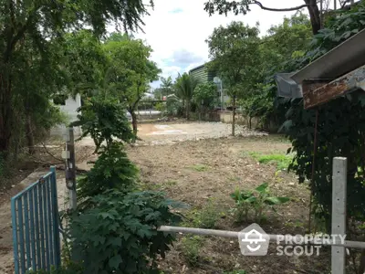 Spacious vacant land plot with lush greenery and potential for development