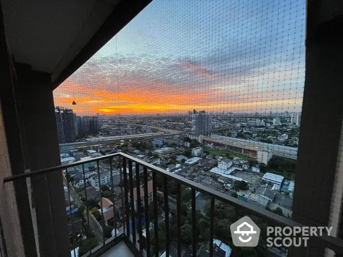 Breathtaking cityscape view from a high-rise balcony at sunset, showcasing a vibrant sky and urban panorama, perfect for relaxation and entertainment.