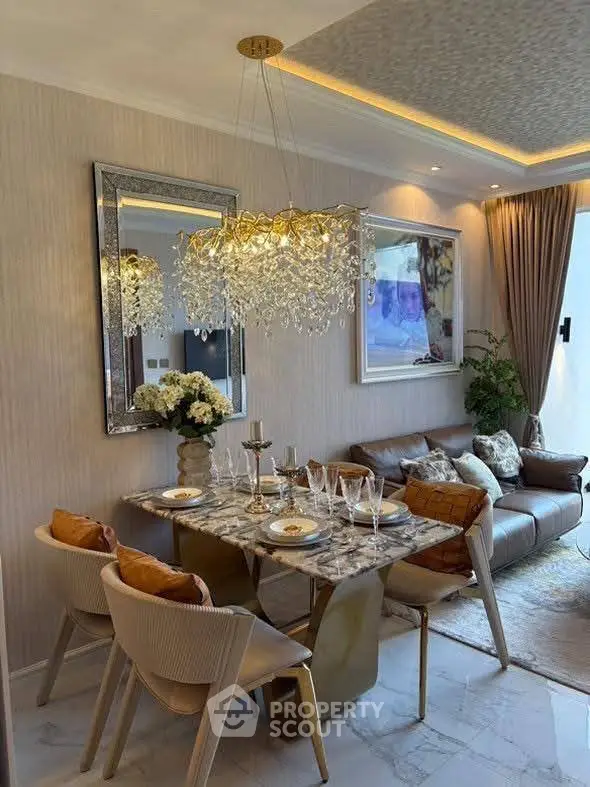 Luxurious living room with elegant dining area and crystal chandelier