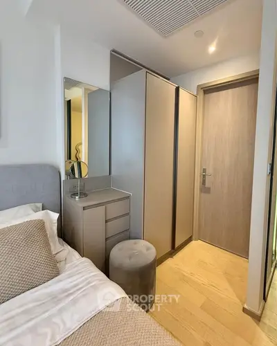 Modern bedroom with stylish wardrobe and cozy bed in contemporary apartment.