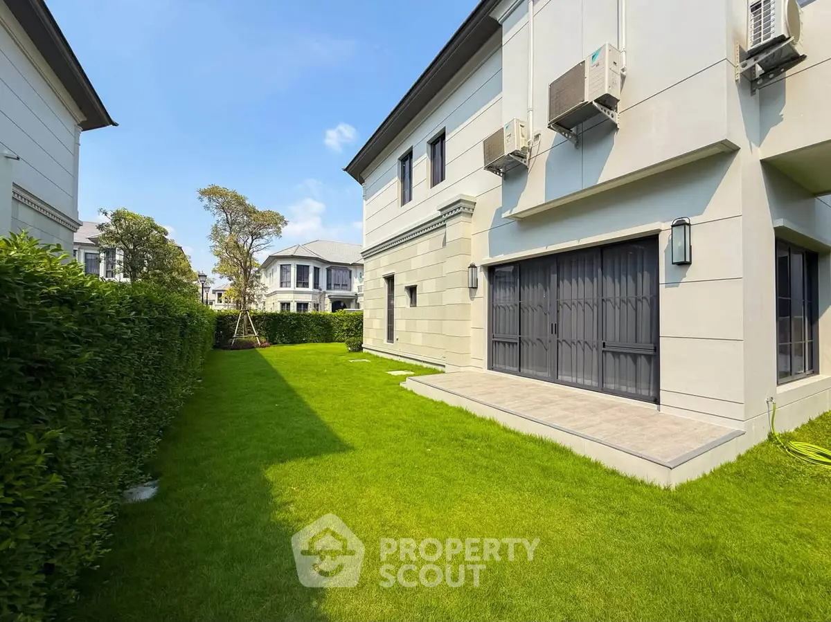 Luxurious modern villa with lush green garden and elegant exterior design.