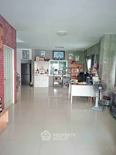 Spacious living room with modern decor and ample natural light