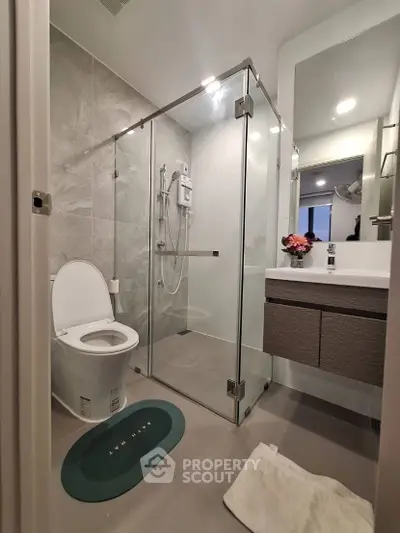 Modern bathroom with glass shower and sleek fixtures