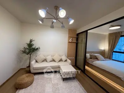 Modern living room with cozy sofa and elegant bedroom view