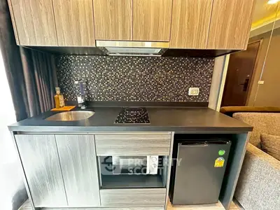 Modern compact kitchen with sleek cabinetry and built-in appliances