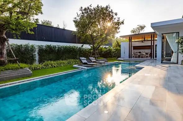 Luxurious modern home with stunning pool and lush garden, perfect for relaxation and entertainment.