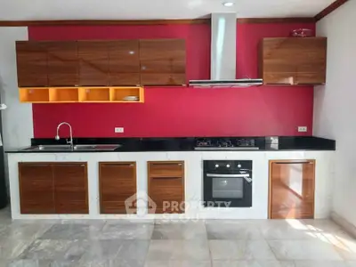 Modern kitchen with sleek cabinets and built-in gas stove and oven