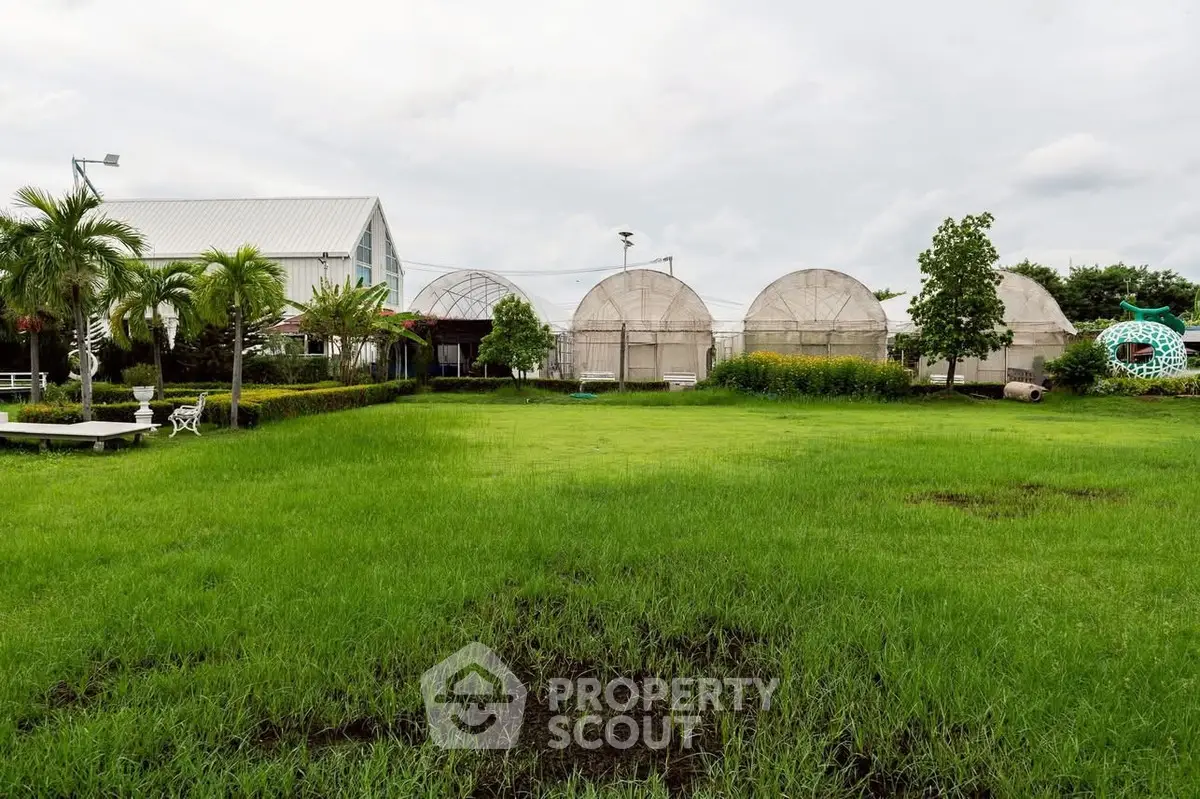 Expansive garden view with lush greenery and unique dome structures, perfect for outdoor relaxation.