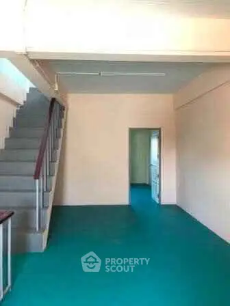 Spacious interior with staircase and vibrant flooring, ideal for creative design opportunities.