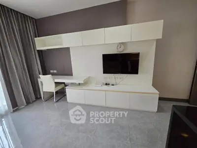 Modern living room with sleek white furniture and wall-mounted TV, perfect for stylish urban living.