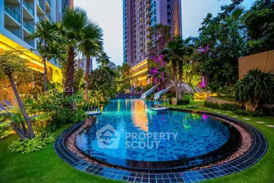 Luxurious residential pool with lush greenery and modern high-rise backdrop.