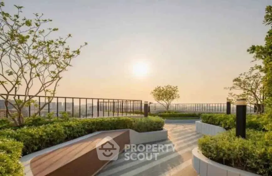 Stunning rooftop garden with panoramic city views and lush greenery at sunset.