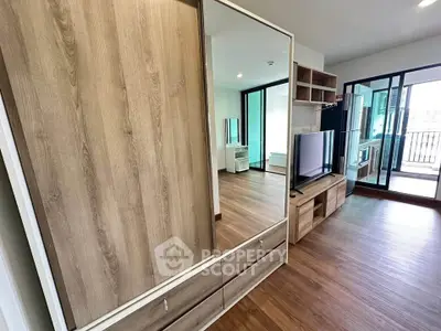 Modern living room with wooden flooring and large mirror wardrobe