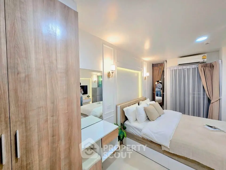 Modern bedroom with cozy decor, wooden wardrobe, and soft lighting for a relaxing ambiance.