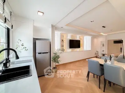 Modern open-layout living room with sleek kitchen and stylish decor
