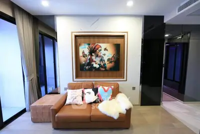 Stylish modern living room with leather sofa and artistic wall decor