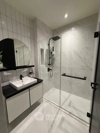 Modern bathroom with sleek shower and stylish vanity in luxury apartment