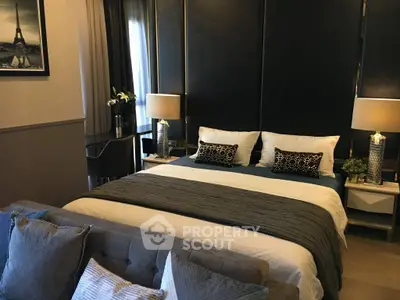 Luxurious bedroom with elegant decor and plush bedding in modern apartment.