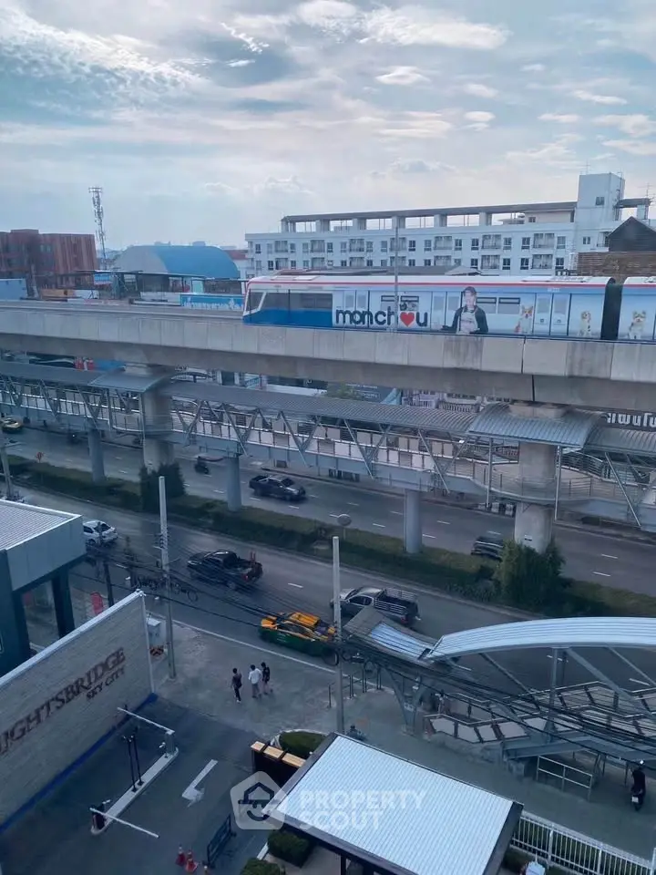 Urban view with elevated train and modern buildings, showcasing city living convenience and connectivity.